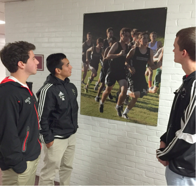 Seniors Jared Edelson, Luis Encinas and Jeff Fisher observe the new pictures hanging in the hallways. 