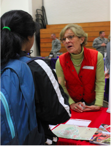 Senior Niki Patel speaks to a representative from Stony Brook University during the October 21 college fair.