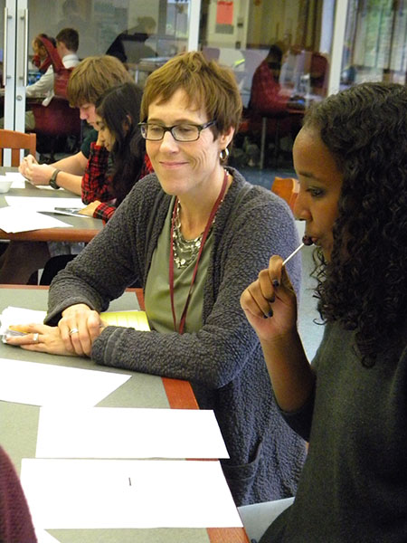 English teacher Tracey Barlow collaborates with sophomore Safaa Buuh on her writing.