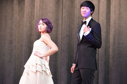 Show off those smiles-- Junior Jillian Maraj and senior Danny Ha pose at the end of the runway and display several prom themed designs. All models’ makeup was done by
LaBelle Chateau before the show.