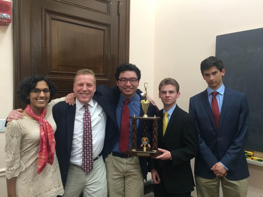 Buzzing in--(Left to right) Senior Nimrita Singh, team coach and economics teacher Joel Nick, junior Allen Haugh and seniors Anthony DiPaulo and Alex Wuschner are presented with the second place trophy in the Harvard Pre-collegiate Economics Challenge (HPEC). The team lost to the Harker School, 45 to 40 in the final round.