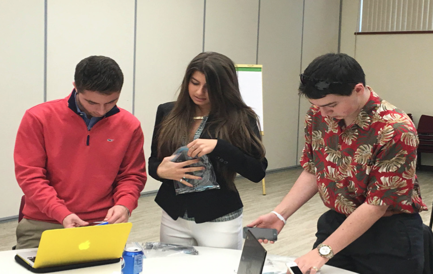Let’s get down to business-- Seniors Russo (left), Rigney (center) and Papaleo (right) meet to discuss their inventory before distribution to make sure it adds up. All three students were recommended for the Academy by business teacher Jeff Daddio.