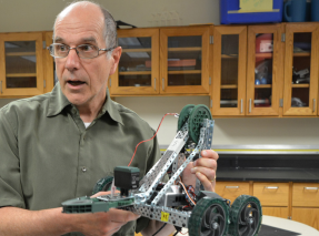 Driving force-- Science teacher Vincent Tokarz reviews and demonstrates the mechanics of a student made motorized project in his third period Engineering class. Tokarz will miss students and his fellow colleagues.