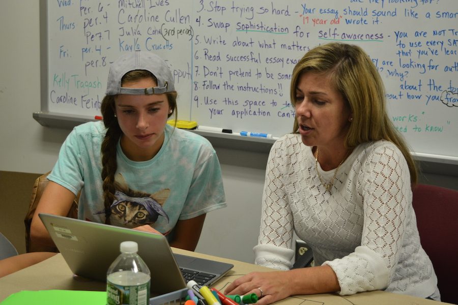College-bound-- Senior Caroline Feinberg works with writing tutor Cindy Moeller on her college essay. Students are finishing their essays for the November 1 deadline.