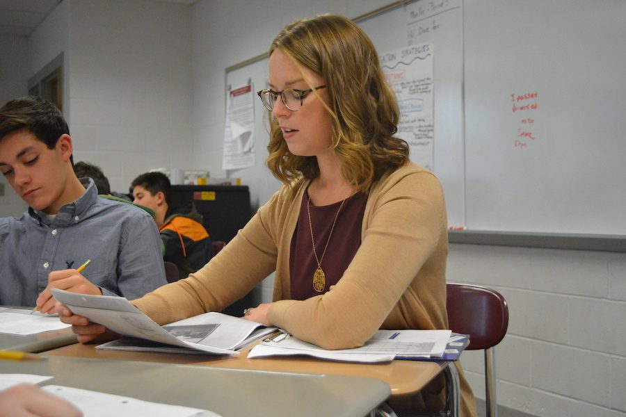 Working together-- Freshman Jake Brickner works with English Department Leader Amy Miller during a read aloud speed-dating exercise. Miller began working at the high school on October 31.