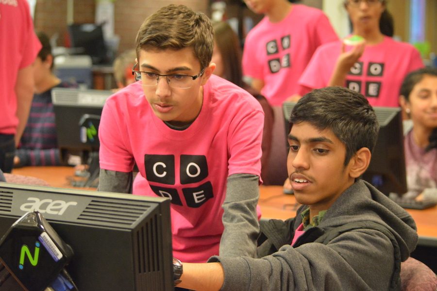 Cracking the code-- Junior Rohan Parikh and sophomore Dhatchinamoorthi Kunde Govindarajan work together on basic 
programming at the annual Hour of Code. Hour of Code took place on December 7 after school in the library and during the school day on December 9. 