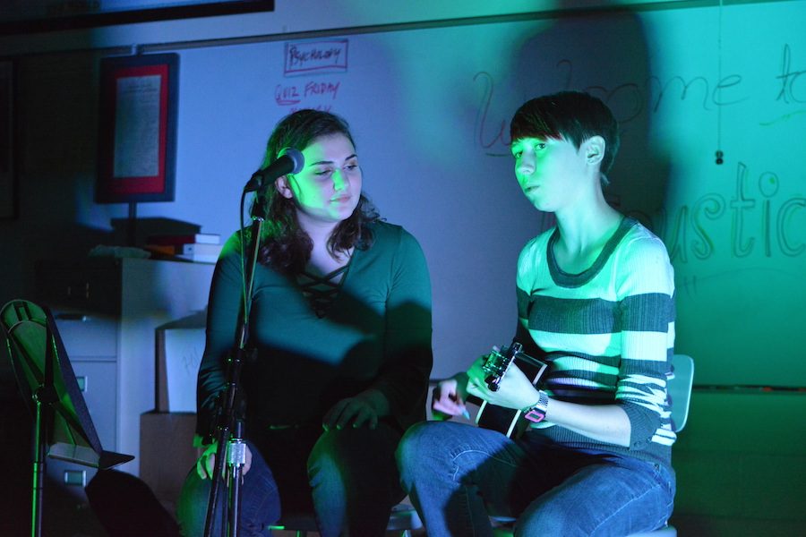 Sing me a song-- Junior Rita Monahan (left) and senior Sarah Davis (right) sing “Here Comes a Thought” by Rebecca Sugar at the annual Acoustic Night on December 9. Acoustic Night is a yearly event that is hosted by the Gay Straight Alliance. 