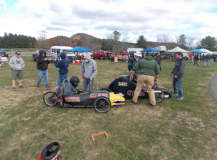 Ready to race-- Students involveed in the Alternate Energy/Vehicle Design Course sit in
their vehicles for the Electrathon event. Electrathon takes place twice a year in Limerock
Park.