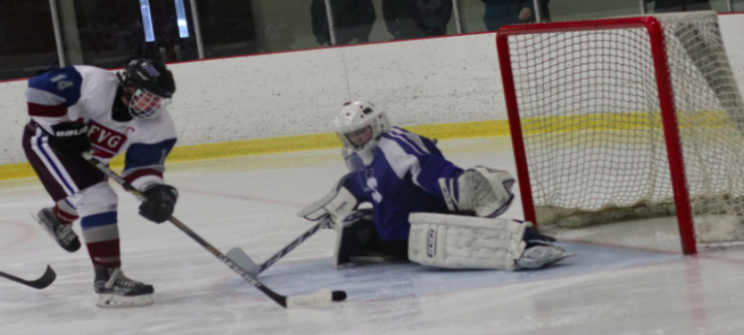 Shooting for the win-- Pucks fly as junior captain Timothy Arena takes a shot in the Generals’ game against Wethersfield.  The Generals beat Wethers eld 3-0 on December 31.