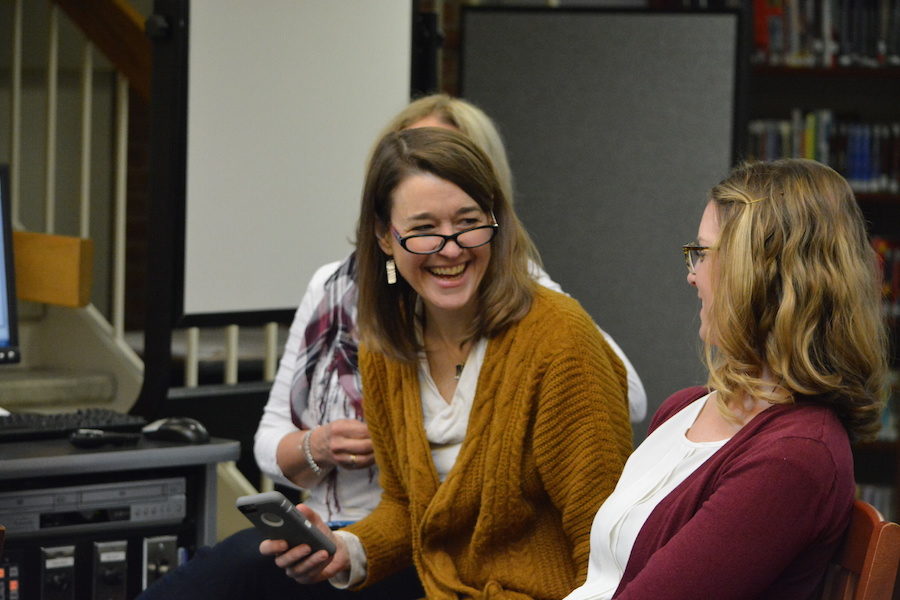 Lots of laughs-- Department Leader for Library, Media and Technology K-12 Martha Burr laughs with English Department Leader Amy Miller during Paul Volponis presentation. Volponi visited the high school on March 24, 2017 and held several presentations throughout the day and a writers workshop during periods six and seven.