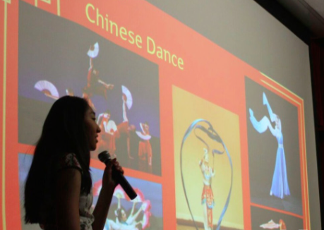 Talk it out-- Junior Caterina Wang speaks to students about traditional Chinese dance before demonstrating it. This presentation took place during the East Asia Day at Irving A. Robbins Middle School (IAR) to guide seventh graders with their research on East Asia.