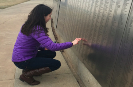 Remembering the past-- Junior Rachel Powell looks at the names of immigrants that passed through Ellis Island engraved in the memorial. Ellis Island served as one of two locations for which immigrants could pass into the United States.