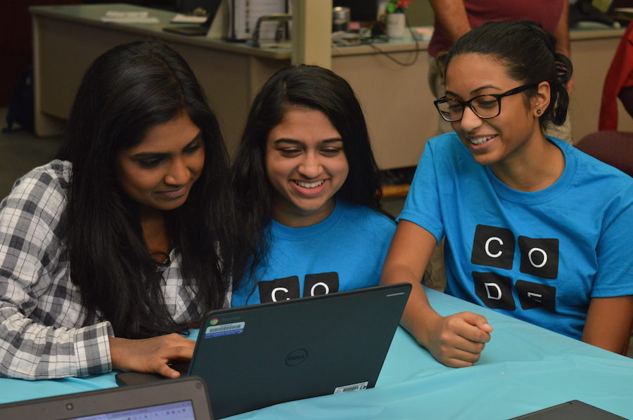 Juniors Shagun Prabhu (center) and Anushka Jami (right) help junior Reya Kalaiarasu (left) as she explores a programming activity. Hour of Code events took place at the high school on December 6 and will continue tomorrow, December 8.