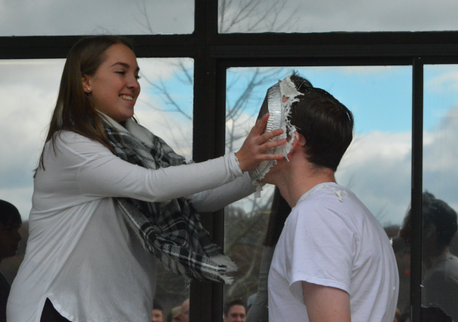 Pied -- Senior Ally Dolmanisth pies social studies teacher Patrick Mulcahy after the senior class won the penny wars competition. The school raised $292 for the cause.