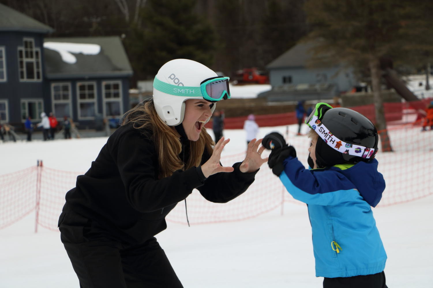 Success in the snow-- Senior Avery Laberge congratulates a young skier during a
lesson. Lessons are between one hour and one hour and a half, and anyone from the
ages three and older can participate.