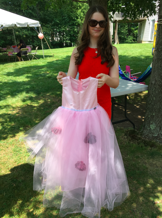 Pretty in pink-- Sophomore Sofia Podgorski poses with a pink ball gown with peonies hiding in the tulles
on the skirt. It was designed for her younger cousin’s birthday party.