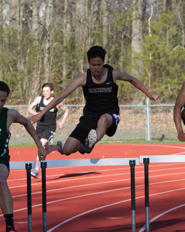 Hurdling over the competition-- Senior Mark Kang leaps over a hurdle during one of last years meets. Although he has no plans to run track in college, this senior is still keeping an open mind. 
