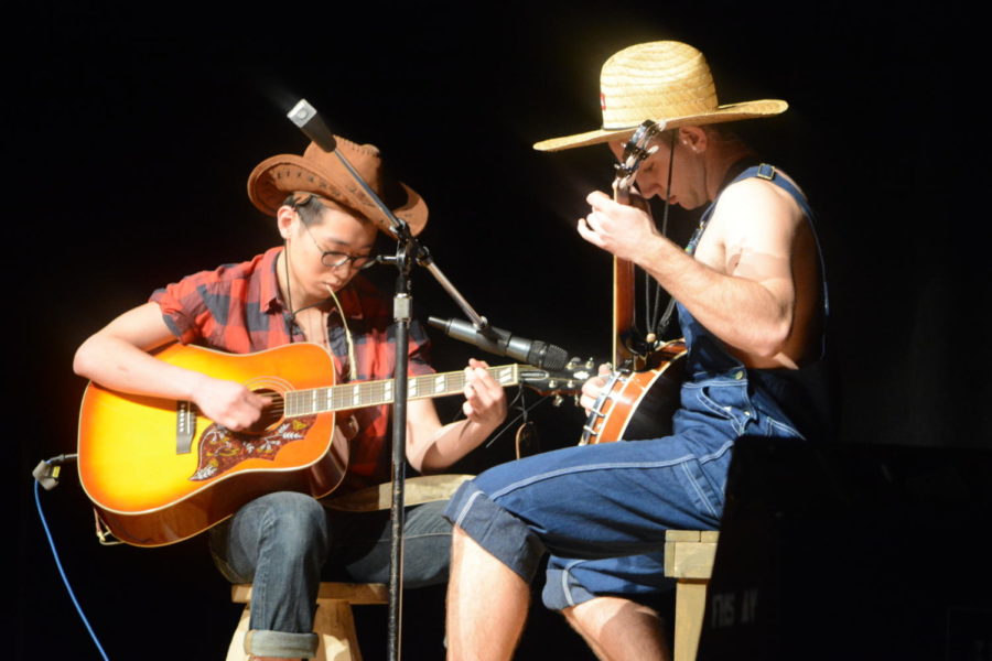 Cream of the crop-- Seniors Travis Cheung (left) and Chris Lagosz (right) start off the talent show with a medley played on the guitar and banjo. The talent show took place on March 23 in the high school auditorium.