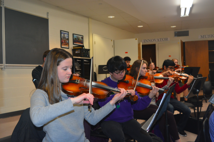 Student Strings-- Sophomore Lucia Hally, junior Astro Abustan, sophomore Caroline Kusmirek, and senior Ishaan Bhatia prepare
for the District Wide Music Festival during their period 4 orchestra class. The Festival featured strings students from throughout the district.
