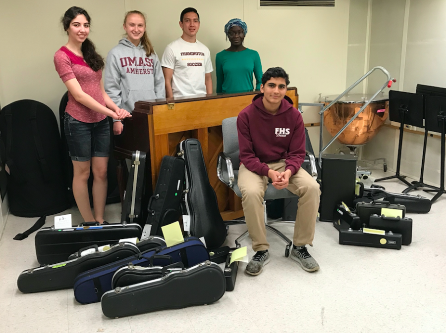 Music to our ears -- Juniors Rohit Limaye (front), Praise Adeloka (left), Kevin Gabree (center left), Anita Ghodsi (right), and senior Sarah Rahmig smile for a photo with some of the instruments obtained by the recent musical instruments drive. The project, spearheaded by Limaye, collected 30 to 40 instruments, which will soon be distributed to elementary-aged students.