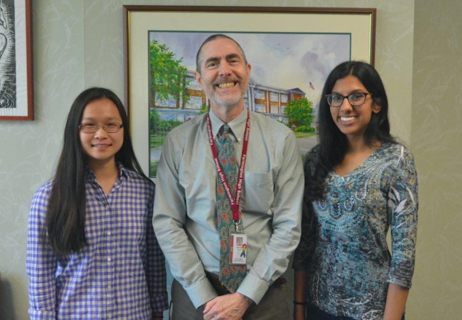 Scholarly students-- Principal Bill Silva (center) congratulates Valedictorian Julie Dong (left) and Salutatorian Navreeta Singh (right) on their academic success as they have been named class Valedictorian and Salutatorian, respectively. Both Dong and Singh will be speaking at graduation, which is scheduled for June 15 on the turf field.