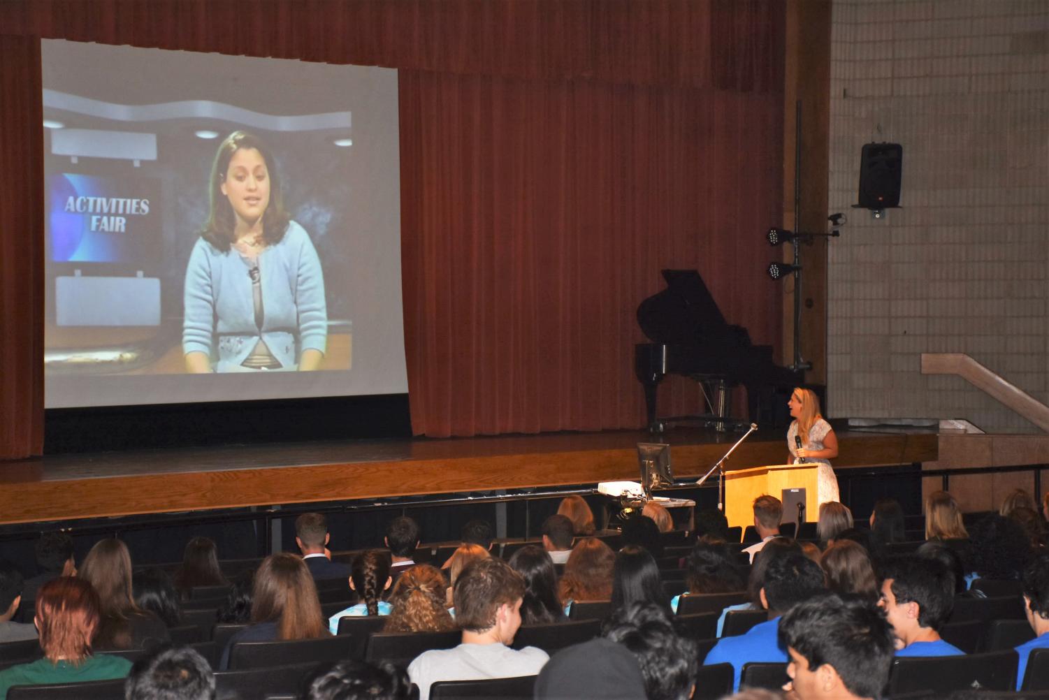 Humble Beginnings-- High school alumna and executive producer for social and emerging media at CNN Worldwide Ashley Codianni watches a clip of herself from her time anchoring the 9:05 News. Senior Convocation took place September 7.