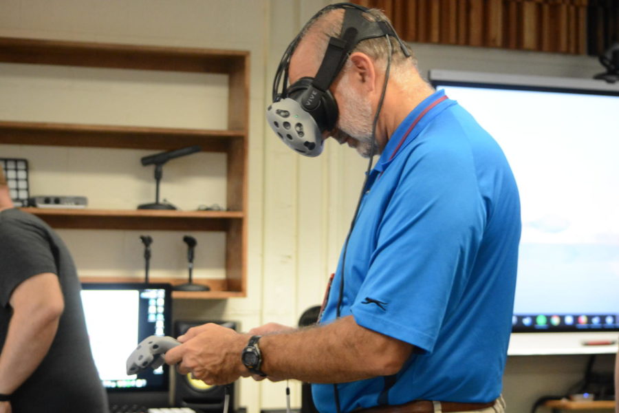 High tech-- Math teacher John Kostal tries on the HTC Vive virtual reality headset at the “Virtual and Augmented Reality in the Classroom” workshop at Professional Learning Exchange (PLX). The event took place at the high school on Tuesday, October 9.
