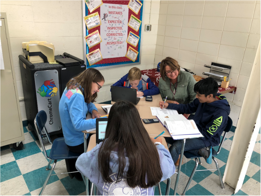 Master teacher-- Irving A. Robbins Middle School math teacher Amy Millar assists students in her class. Millar has taught at the middle school for 31 years. 
