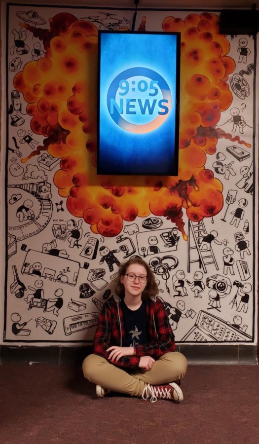 Artistic+force--Sophomore+Yana+Tsyvis+sits+in+front+of+the+mural+she+completed+that+is+located+outside+the+Edge+Media+room.+The+mural+took+many+weeks+to+complete.+