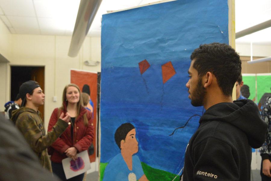 Paint night-- Senior Wallaf Monteiro speaks with attendees at the multicultural art show that took place on March 22. Under the theme Sharing Our Stories Through Art, the students creatively shared with the community their multicultural identities. 
