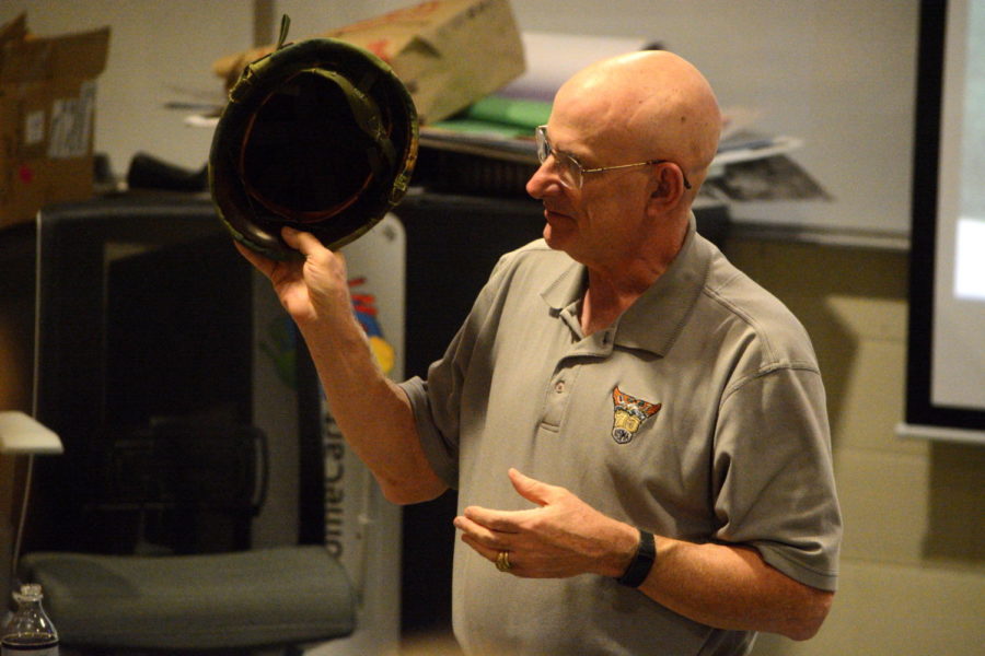 Wear your helmet-- Vietnam-era veteran Bob Thomas shows American Studies students the M1 helmet. Thomas visited American Studies students to show them his military equipment to supplement their classroom learning. The students are currently engaged in a unit of study that focuses on the responsibilities of Vietnam soldiers. 