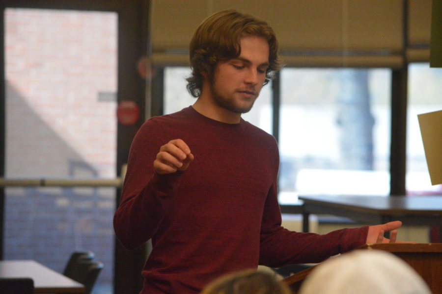 Spoken word-- Senior Liam Hemingway shares his original poem, A Flock of Birds on April 29 in the library. His performance was part of a unit on spoken word poetry in English teacher Virginia Gillis Poetry Honors class. 