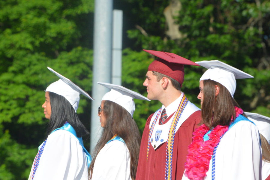 Future leaders-- (left to right) Senior Class council members Joanne Le, Sam Gabree, Greg Lagosz, and Sam Ruh listen to speakers during the 2019 Commencement. Graduation took place June 12.