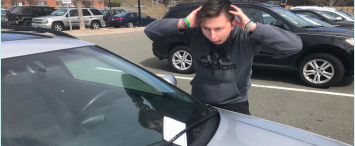 Don’t do the crime, if you can’t do the time-- Senior Ethan Blumes stands upset over a parking ticket
embedded beneath the windshield wiper of his car after failing to adhere to the parking guidelines. Failure to
pay the required parking pass fee results in both tickets and possible boots on tires.