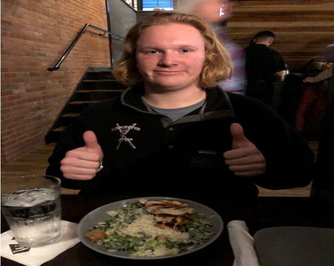 Dinner is served-- Junior Cullen Laberge enjoys a meal at the newly
located Wood-n-Tap location. The restaurant has moved right across the
street from the high school.