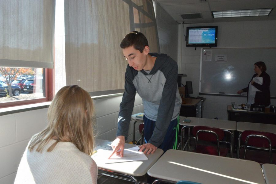 Lending a helping hand-- Senior Matt Adamski works with junior Julia Nowak in AP U.S. History. Students

who wish to get involved with being a teacher’s assistant should speak with their teachers about the opportu-
nity.