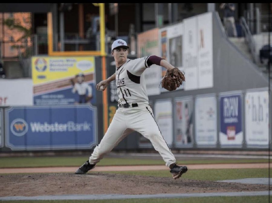 FHS senior Tyler winds up to pitch during a 2019 game at Dunkin Donuts Park. 