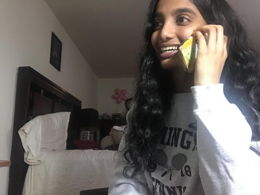 Only one call away -- Junior Saathvika Diviti speaks with a Farmington senior citizen over the phone. Diviti and other students are able to volunteer and support members of the community during the COVID-19 pandemic. 