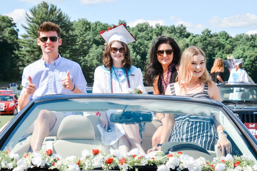 Drive-thru diploma-- (left to right) Junior Ricky Podgorski, senior Sofia Podgorski, parent Amy Podgorski, and 2018 alumna Bella Podgorski celebrate graduation from their car. Graduation was held on June 14 at the Farmington Polo Grounds in a drive-thru format due to the COVID-19 pandemic.