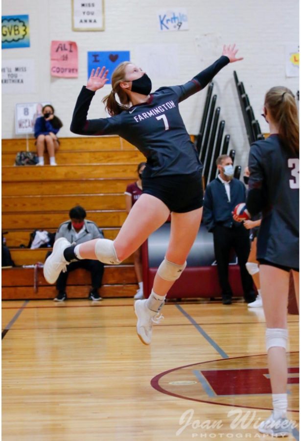 Senior Night Sweep-- Middle hitter for girls volleyball senior Georgia Hughes sets up a spike. The girls
won the first three sets against New Britain at home on October 8.