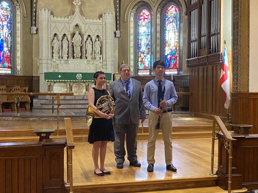 Hard work pays off -- After weeks of preparation, senior Andy Dong (right) performed for the Nutmeg Symphony Orchestras Young Artist Competition. The competition was hosted at Trinity Episcopal Church and organized by Marshall Brown (middle).