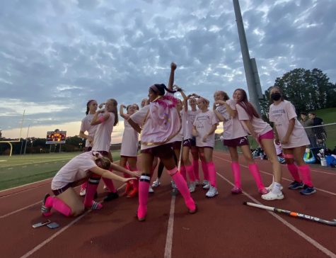 Playing for a cure — Senior captain Sonali Patel stands in front of the field hockey team, all dressed in pink to support breast cancer awareness. Patel scored one of the two goals in the 2-0 win against Pomperaug. 