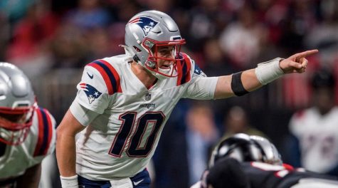 Rookie rising to the top -- Patriots quarterback Mac Jones directs the team during their 25 - 0 win against the Atlanta Falcons on November 18. The New England Patriots are the number one seed in the AFC. 