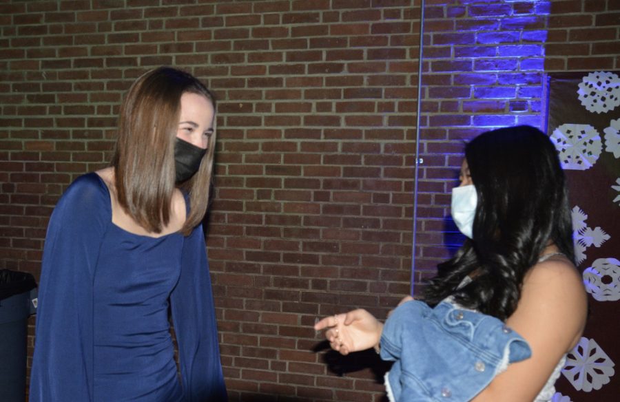 What fun this is-- Juniors Abby Finn (left) and Grace Ortiz (right) laugh with each other during the winter semi-formal dance. Student council organized the dance for all students to attend.