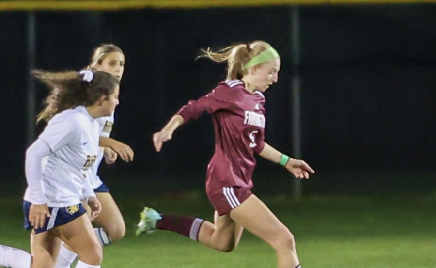 River Hawk on the run-- Junior Hannah Sams runs down the field with possession of the ball during the teams game against RHAM high school. Sams and the girls soccer team ended their season after a postseason run in the CIAC tournament playoffs. 