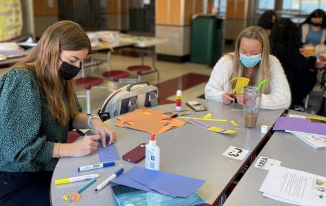 “I have a dream”-- Juniors Sydney Bigelow (left) and Mia Greco (right) work on creating
literacy kits for families in need after school on January 18. This was organized by nine
different clubs in honor of Martin Luther King Jr. day.