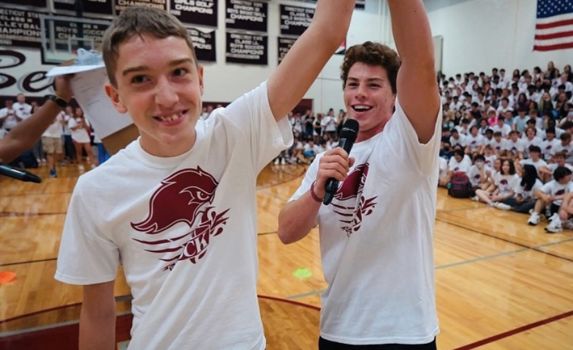 Champion -- Senior Luke Watson (right) raises freshmen Keane Murphy’s (left) arm after he won the Flipping for Friends competition. The event took place to raise money for the high school friends program and was a huge success. 