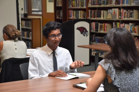 Capstone conversations -- Senior Akshaj Ganta meets with a professional during the Capstone networking event. Representatives from different career fields attended the event to meet with Capstone students.