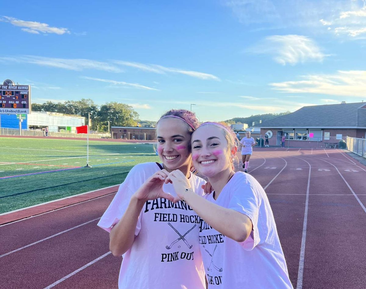 Junior Paige Bigelow (left) and Senior Courtney Meeker (right) pose together at the annual Field Hockey teams Pink Out Game. The event, held on October 13, 2023 raises support and awareness for Breast Cancer research.