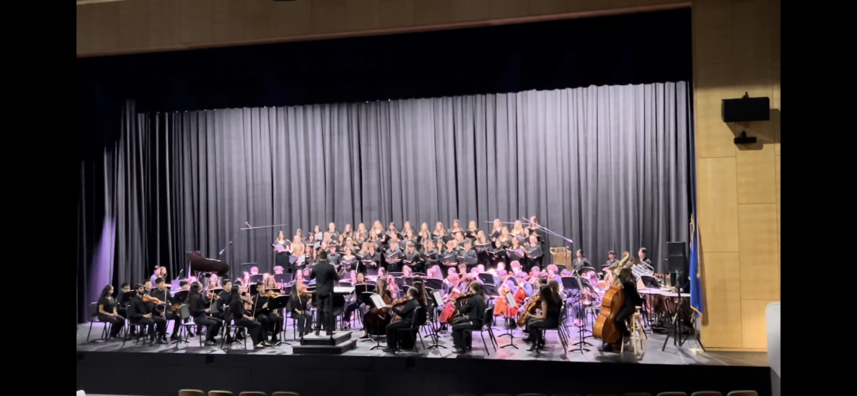 1, 2, 3 and 4! -- Symphony Strings (front center), Wind Ensemble (right), Chamber Singer and Advanced Treble Chorale (back), led by  teacher Jeffrey Ventres, perform Carmina Burana for the audience in the new FHS auditorium. The concert, Fright Fest, took place on October 16th.

